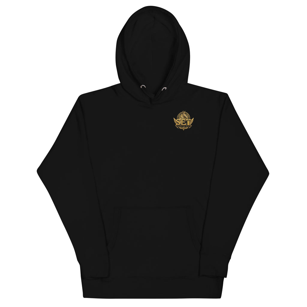 Black premium pullover hoodie with the gold-tone SET Anubis crest on the wearer’s left chest — front view.
