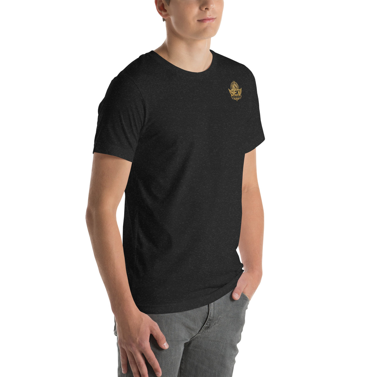 Black heather unisex staple T-shirt with the gold-tone SET Anubis crest on the wearer’s left chest — front-right view.